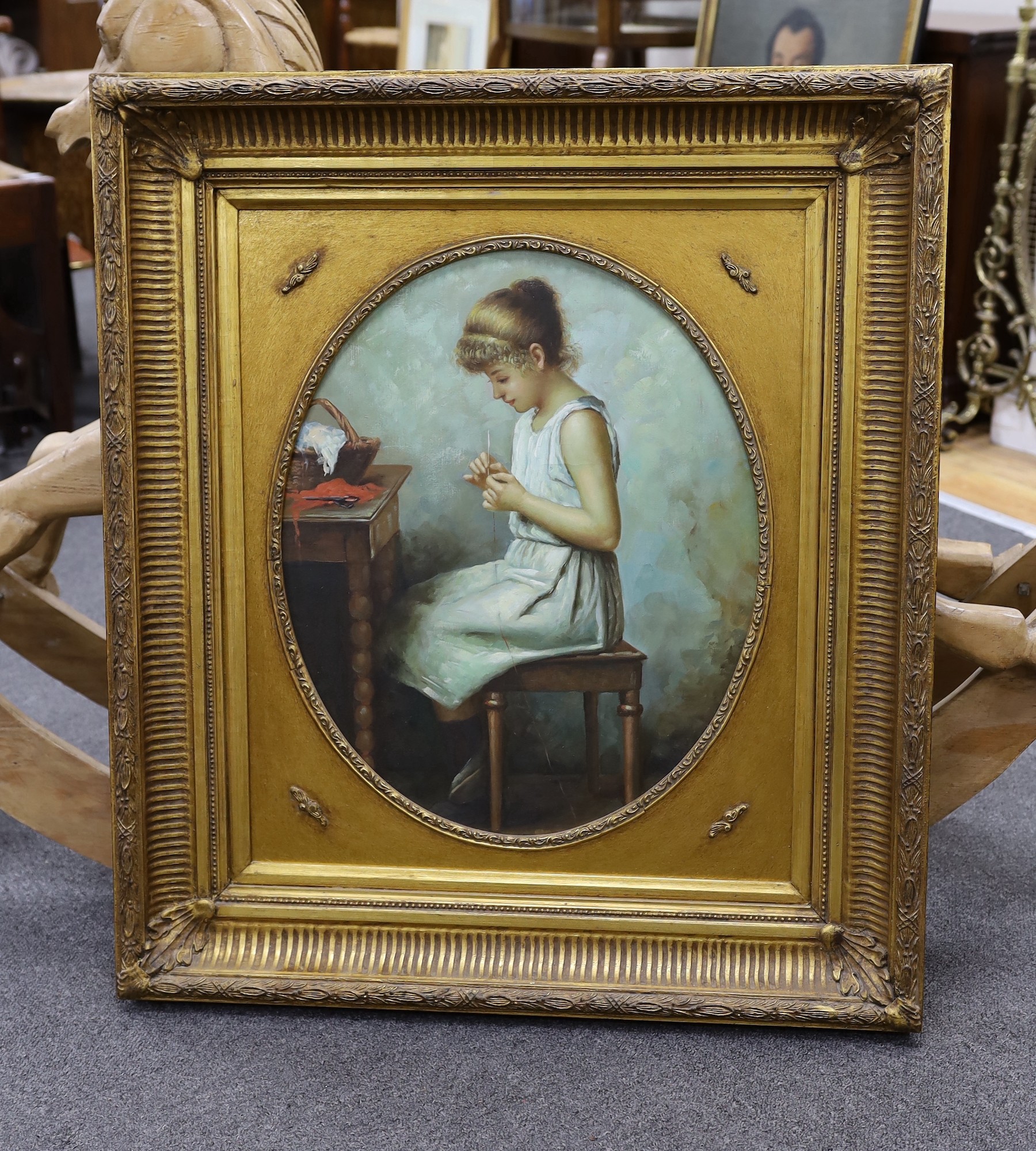 After Alexi Harlamoff (Russian, 1848-1915), oil on canvas, Young girl sewing, framed to the oval 53 x 43cm